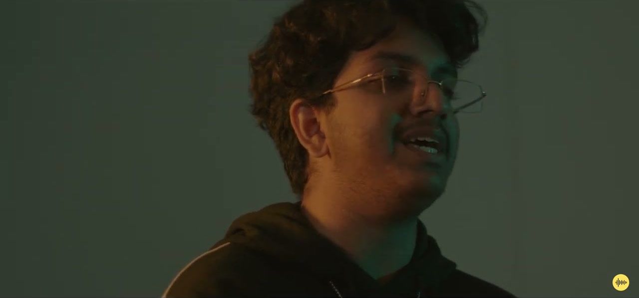 A singer in teal light, from the Lovely cover