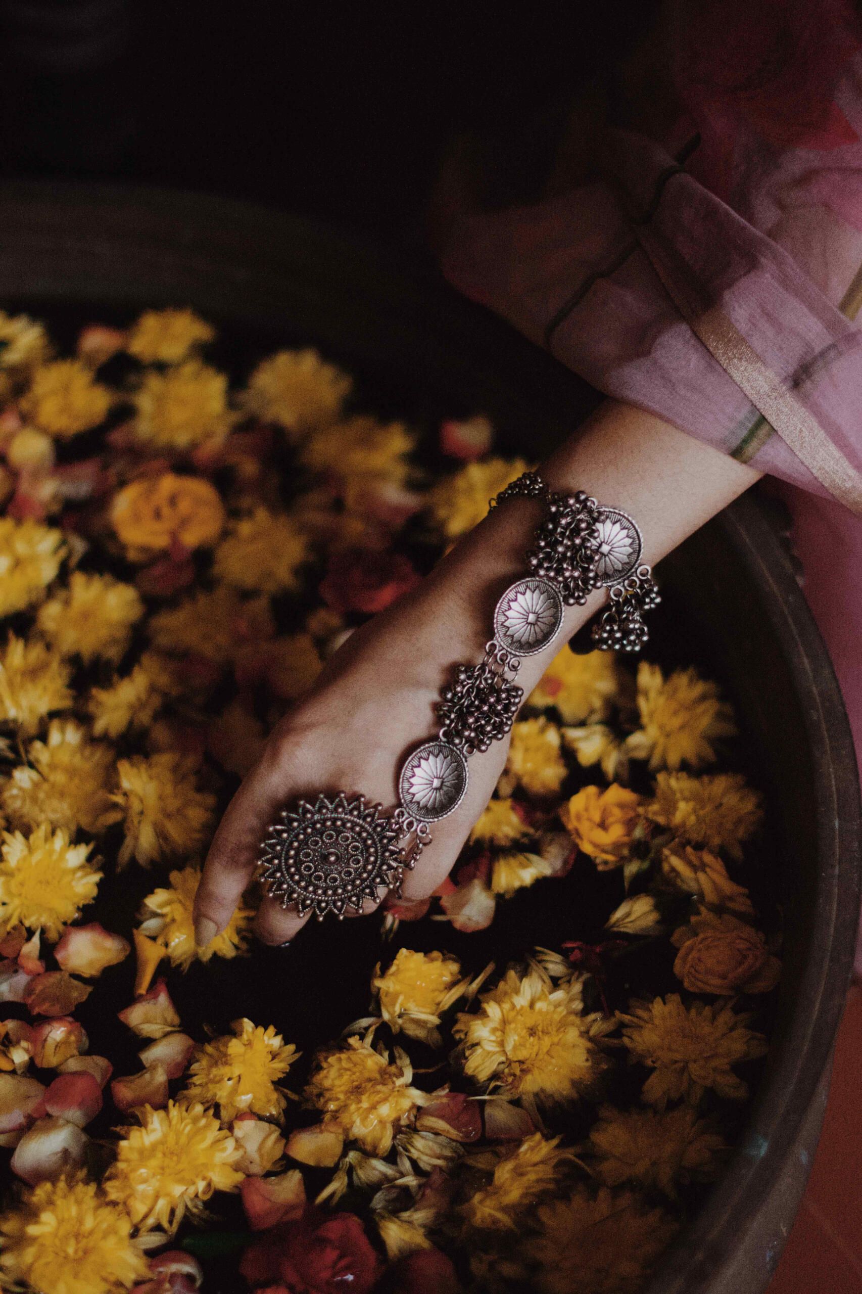 Silver rings on a hand among marigolds